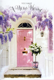 The photograph presents a beautifully composed entranceway in Southgate, turned into a serene celebration of home with flowers and soft colour. Framing the top of the image, trailing branches of wisteria descend in generous clusters, each bloom a gentle shade of lavender that deepens to a duskier purple at the tips. These cascading flowers create a natural arch over a pastel pink door, whose smooth, painted panels glow quietly in the diffused daylight, reminiscent of the calm streets around Southgate Circus on a still afternoon. The door is set within clean, whitewashed walls that feel cool and slightly textured, catching subtle shadows from the wisteria above. To one side, a matching pale pink shutter adds balance, echoing the door's friendly tone and drawing the eye across the façade. On the stone doorstep sits a modest grey metal bucket, transformed into something special by its contents: a lush, overflowing bouquet of white and cream roses, their petals full and soft, layered like folded silk. The roses are interlaced with simple green foliage, bringing freshness and a hint of garden life to the scene, as though just gathered from a nearby Southgate garden. Around the bucket's base, a delicate pink ribbon is tied in a loose bow, its satin surface catching the light in small, quiet highlights. Everything in the image-the pastel colours, the hanging blossoms, the neat step-works together to evoke tenderness, hope, and the intimate thrill of moving into a new home, perhaps after a walk back from Southgate Underground station, key in hand and heart full of anticipation.